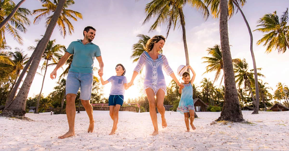 family jumping on the beach