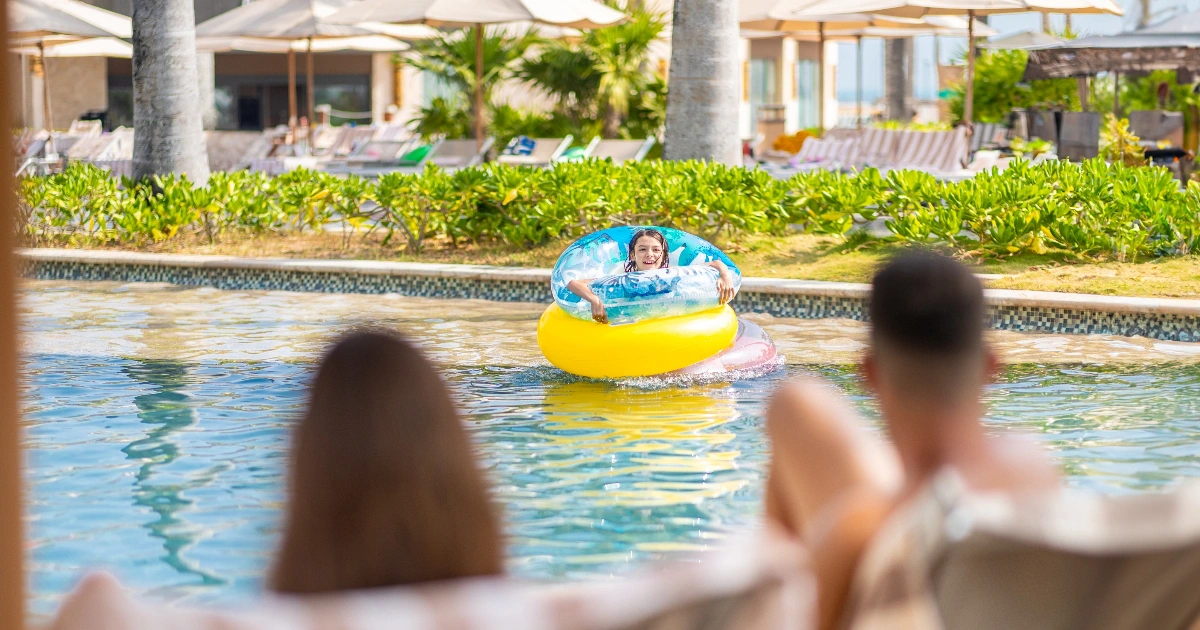Family enjoying the pool area at Villa del Palmar Cancun.
