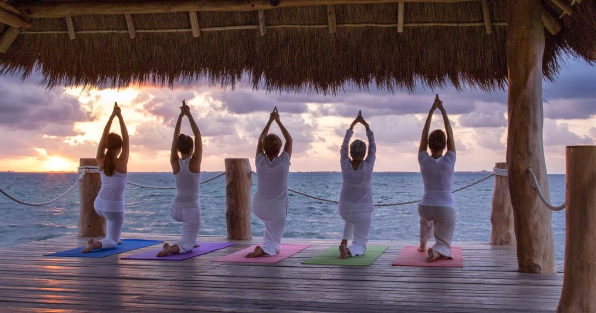 Yoga session on the beach at Villa del Palmar Cancun.