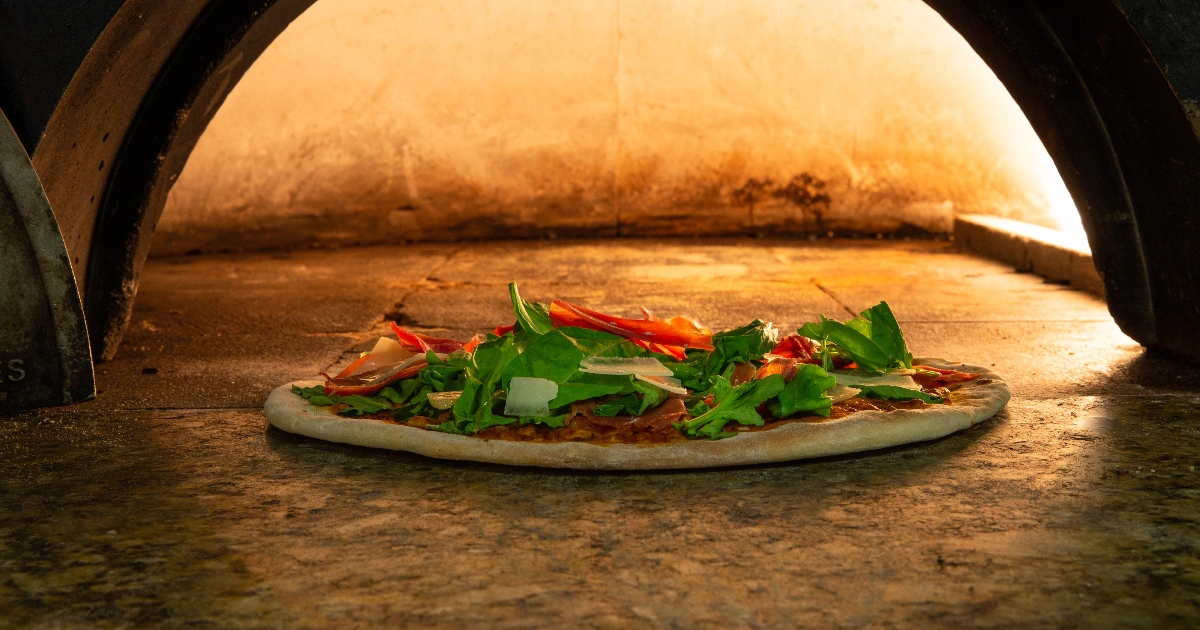 Delicious pizza served at Davino restaurant, Villa del Palmar Cancun, featuring fresh ingredients and a perfect crust.