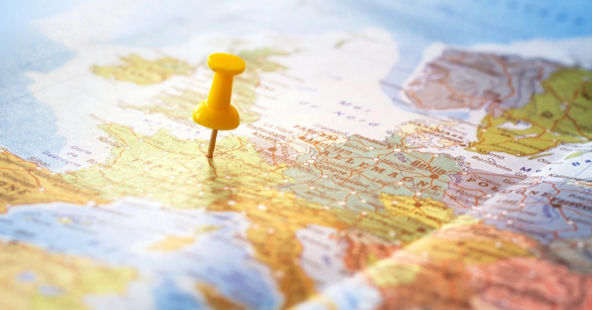 Paper map with a red pin
