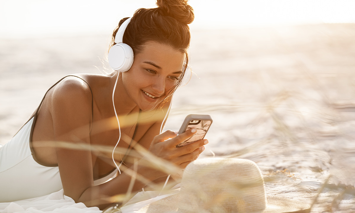 girl listening music on the beach