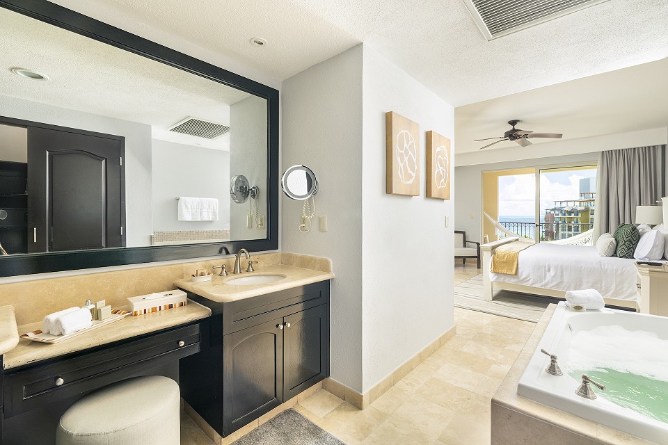 en suite bathroom with whirlpool bathtub